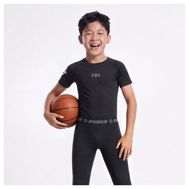 Rigorer kids compression shirt in black, close view of the crew neck and chest mark